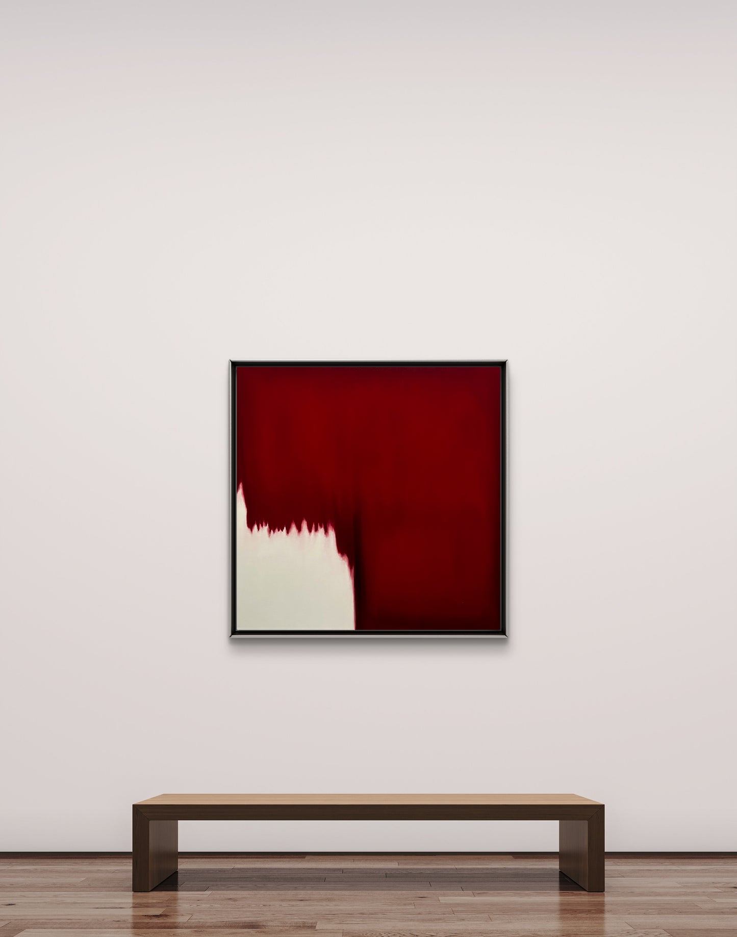 Abstract red painting on a white wall with a wooden bench below