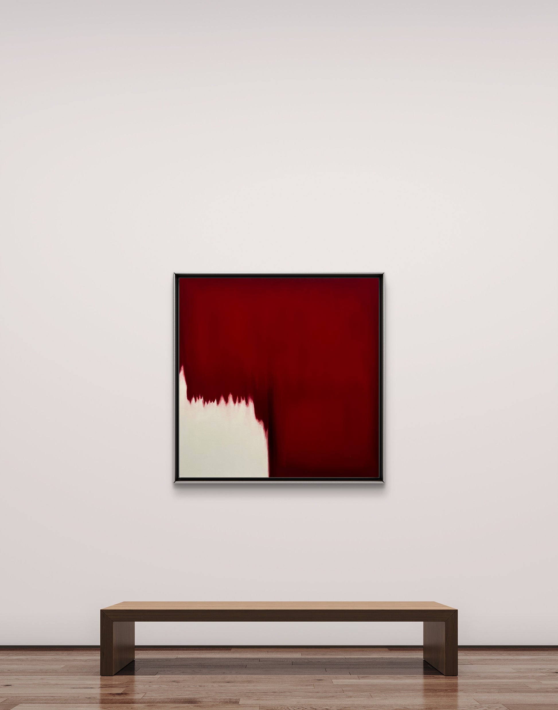 Abstract red painting on a white wall with a wooden bench below