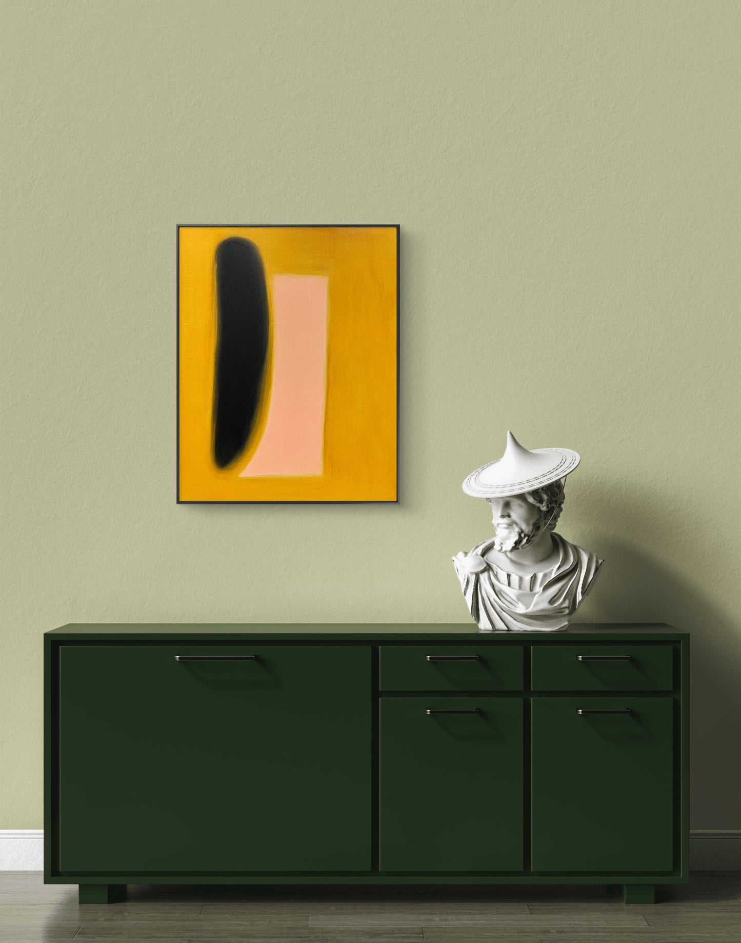 Green cabinet with abstract art and statue against a beige wall