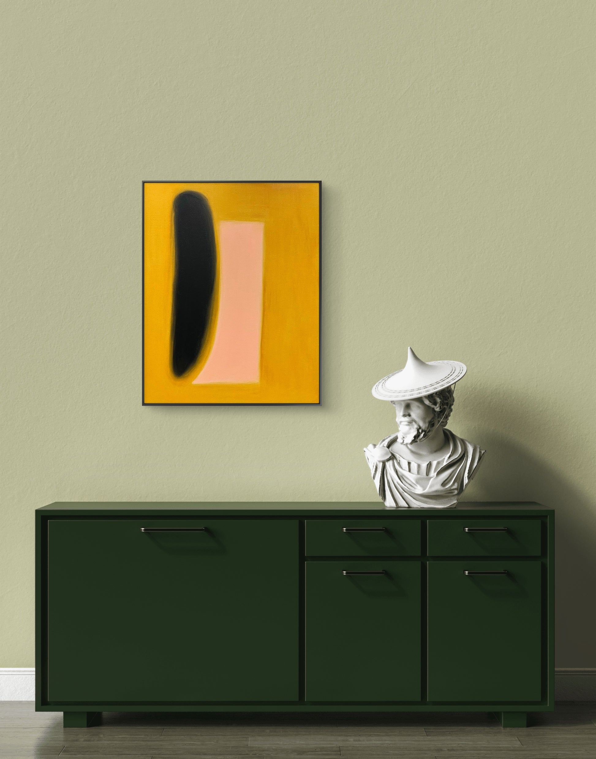 Green cabinet with abstract art and statue against a beige wall