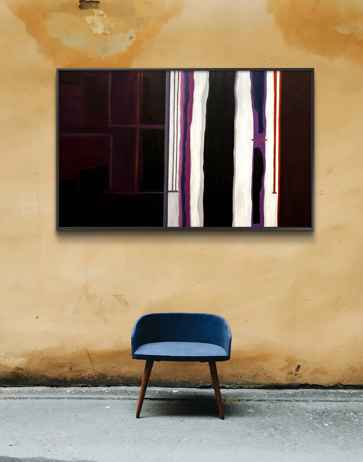 Abstract art piece on a wall with a blue chair below it.